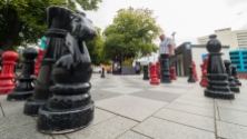 The camera almost at ground level, focus not the foreground chess piece.